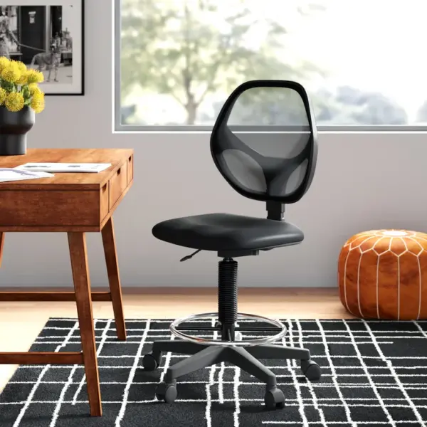 Black reception/cashier office chair, office chairs, reception chair next to a flower in a vase.