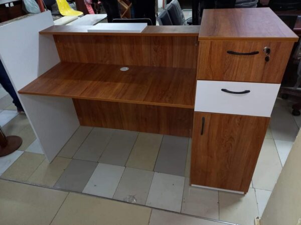 reception desk, modern reception desk, office reception desk, front office desk, reception counter, reception table, salon reception desk, hotel reception desk, business reception desk, contemporary reception desk, L-shaped reception desk, U-shaped reception desk, wooden reception desk, glass reception desk, custom reception desk, compact reception desk, stylish reception desk, small reception desk, large reception desk, curved reception desk, luxury reception desk, modular reception desk, affordable reception desk, reception desk with drawers, reception desk with shelves, reception desk with storage, minimalist reception desk, premium reception desk, reception area furniture, reception workstation, executive reception desk, reception desk Kenya, reception desk Nairobi, office reception counter, reception furniture set, front desk, receptionist table, office front desk furniture, modern lobby desk, reception desk design, elegant reception desk, reception desk with lighting, curved front desk, reception counter with signage, high-end reception desk, custom-built reception desk, front office furniture, salon front desk, front counter, sleek reception desk, minimalist front desk, front desk for office, welcome desk, boutique reception desk, compact lobby desk, office entrance desk, front office workstation, modular front counter, modern entry desk, executive lobby desk, office receiving counter, reception desk with branding panel, hotel front desk, dental reception desk, medical reception desk, front counter furniture, classic reception desk, durable reception desk, high gloss reception desk, matte finish reception desk, front desk with LED lights, acrylic reception desk, metal reception desk, ergonomic reception desk, compact welcome desk, professional reception desk, multi-level reception desk, front office reception unit, open front reception desk, front desk with privacy screen, two-tone reception desk, reception area counter, visitor greeting desk, clinic reception desk, bank reception desk, customized reception counter, reception bar counter, office welcome counter, modern business desk, curved reception counter, school reception desk, institution front desk, portable reception desk, reception desk with wheels, reception counter with cabinet, high reception counter, corporate reception desk, reception desk for entrance, showroom reception desk, retail front desk, aesthetic reception desk, reception kiosk, entry point reception counter, dual-level reception desk, office check-in counter, reception corner desk, front office check-in table, small office front desk, waiting area reception desk, reception counter with display shelf, reception furniture solutions, branded reception desk, luxury front office desk, home office reception desk, minimalist lobby desk, front office design table, interior reception furniture, front desk with drawers and shelves, welcome area desk, reception bench with desk, reception podium, reception desk package, office entry desk, multifunction reception table, laminated reception desk, melamine reception desk, woodgrain reception desk, black reception desk, white reception desk, brown reception desk, grey reception desk, executive front desk, professional front office table, business welcome desk, corporate welcome table, office furniture front desk, reception office set, waiting room counter, modern reception counter furniture, reception furniture Kenya, reception tables Nairobi, front desk installation, best reception desks Nairobi, affordable front office desk Kenya, top reception desk suppliers Kenya, modern office entrance desk, reception desk with file storage, salon counter design, stylish entrance desk, decorative reception table, entry desk with signage holder, reception desk with drawers and cabinet, client greeting table, reception setup furniture, office lobby interior furniture, customer care desk, front area counter, client service desk, welcome counter, reception workstation furniture, waiting area desk unit, reception desk for lobby, reception unit with lockable drawers, secure reception counter, reception desk with filing space, workstation reception combo, reception furniture arrangement, entry point desk for business, high-traffic reception desk, workstation style reception table, hospitality front desk, office desk for reception area, open reception counter, panel-based reception desk, low reception counter, double-sided reception desk, open plan reception desk, compact front desk for small offices, reception desk furniture solution, elegant front desk furniture, best reception desk design, multi-purpose reception table, reception console desk, reception area workstation, front desk workspace, ergonomic receptionist desk, retail store reception desk, multifunctional reception furniture, workstation and reception combo, durable front office desk, visitor handling desk, greeting area counter, reception console, office reception design ideas, and reception counter with nameplate.